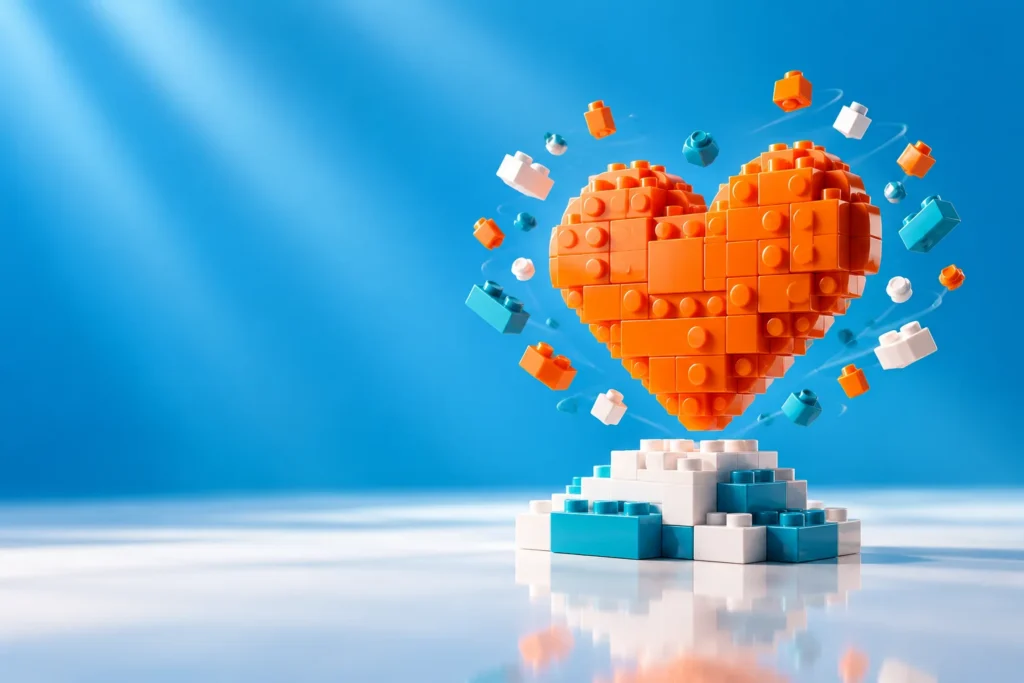 Glossy orange brick heart floating above a stack of bricks